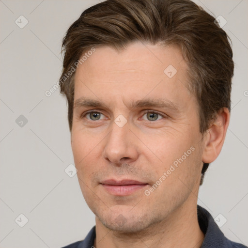 Joyful white adult male with short  brown hair and brown eyes