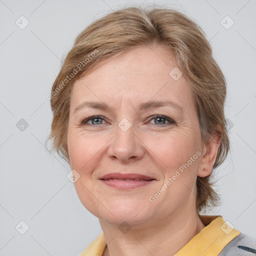 Joyful white adult female with medium  brown hair and blue eyes