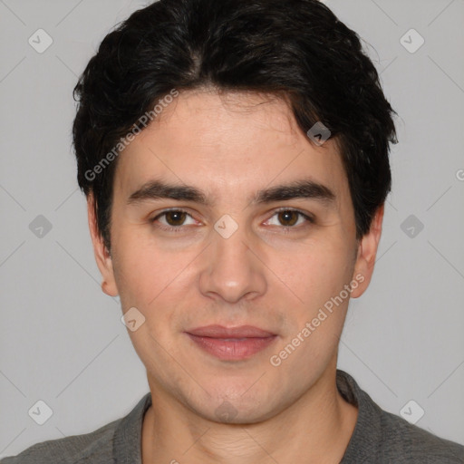 Joyful white young-adult male with short  black hair and brown eyes