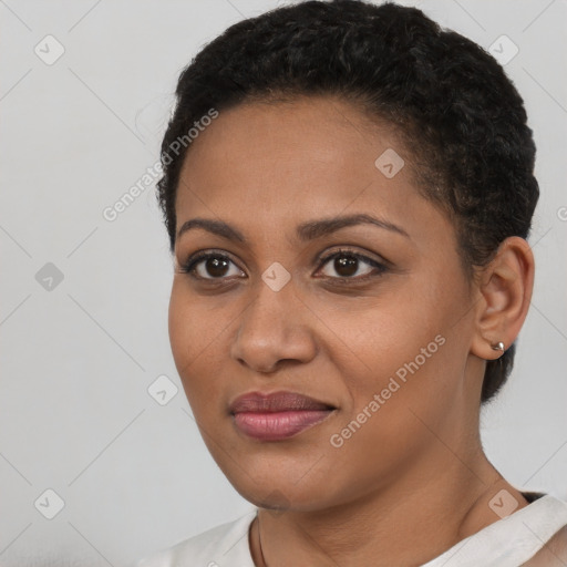 Joyful black young-adult female with short  black hair and brown eyes