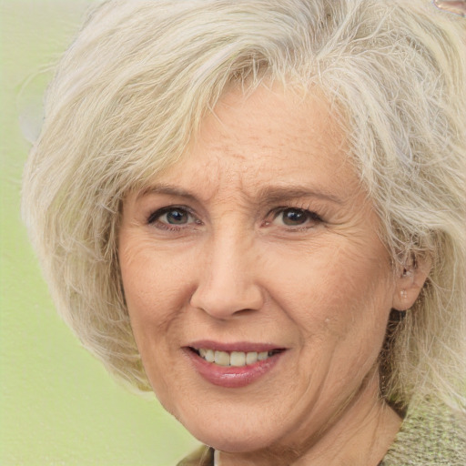 Joyful white middle-aged female with medium  blond hair and brown eyes