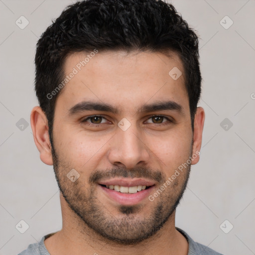 Joyful white young-adult male with short  black hair and brown eyes