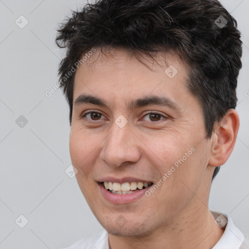 Joyful white young-adult male with short  brown hair and brown eyes