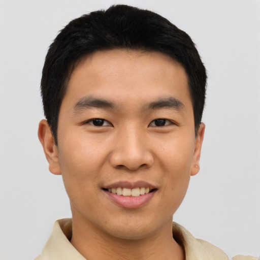 Joyful asian young-adult male with short  black hair and brown eyes