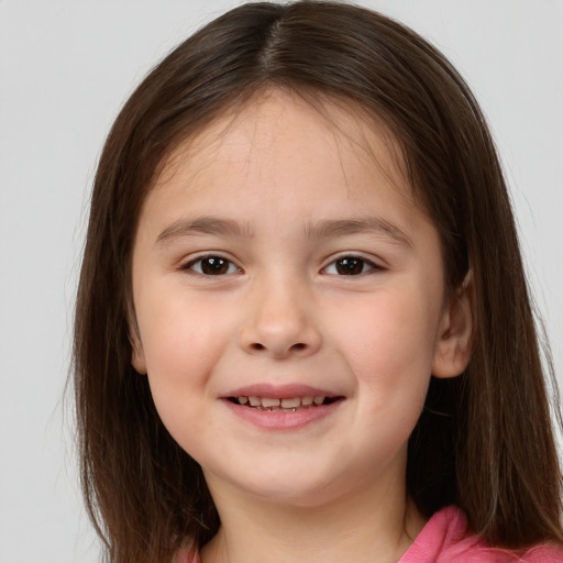 Joyful white child female with medium  brown hair and brown eyes