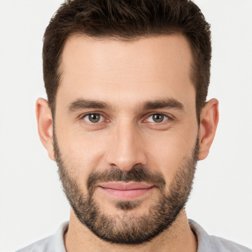 Joyful white young-adult male with short  brown hair and brown eyes