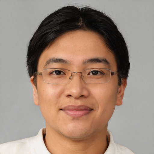 Joyful latino adult male with short  brown hair and brown eyes