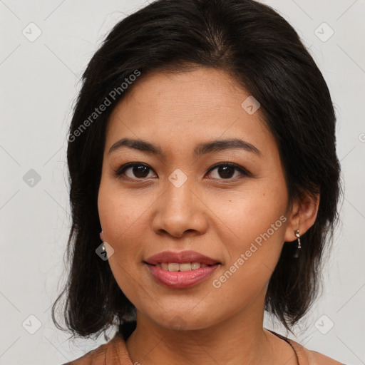 Joyful latino young-adult female with medium  brown hair and brown eyes