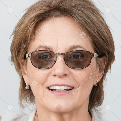 Joyful white adult female with medium  brown hair and blue eyes