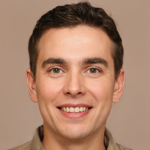 Joyful white young-adult male with short  brown hair and brown eyes