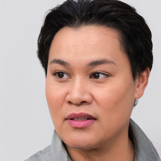 Joyful asian young-adult female with short  black hair and brown eyes