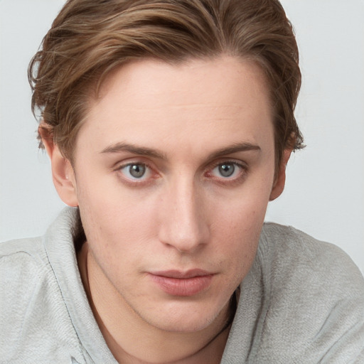 Joyful white young-adult female with short  brown hair and blue eyes