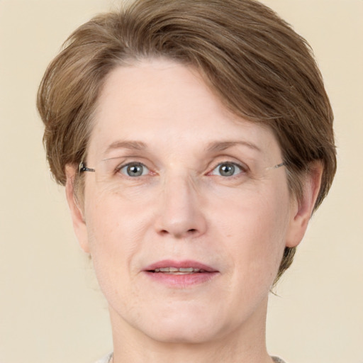 Joyful white adult female with medium  brown hair and grey eyes