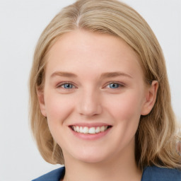 Joyful white young-adult female with medium  brown hair and blue eyes