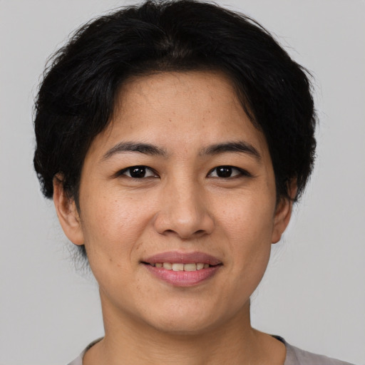 Joyful asian young-adult female with short  black hair and brown eyes