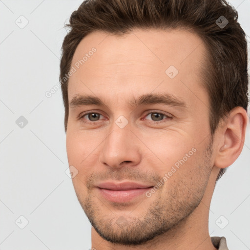 Joyful white young-adult male with short  brown hair and brown eyes