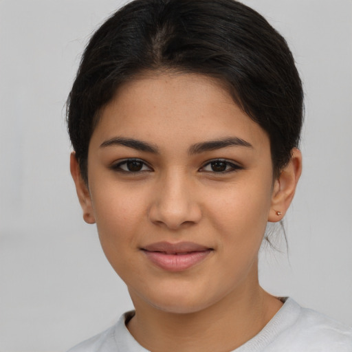 Joyful latino young-adult female with short  brown hair and brown eyes