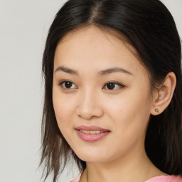 Joyful asian young-adult female with long  brown hair and brown eyes