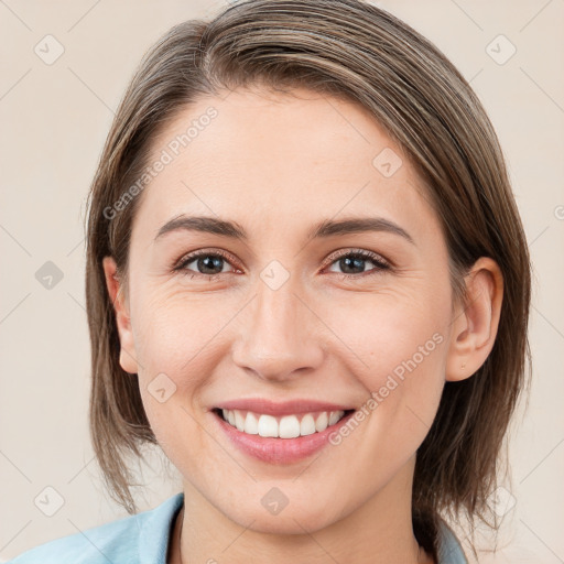 Joyful white young-adult female with medium  brown hair and grey eyes