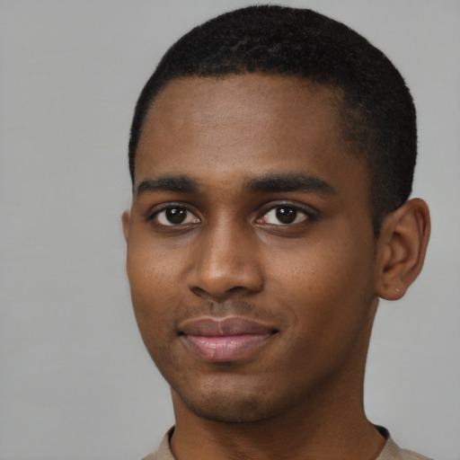 Joyful black young-adult male with short  black hair and brown eyes