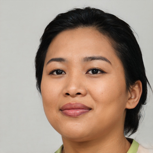 Joyful asian young-adult female with medium  black hair and brown eyes