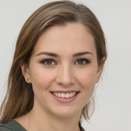 Joyful white young-adult female with medium  brown hair and grey eyes