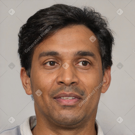Joyful latino adult male with short  black hair and brown eyes