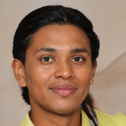 Joyful latino young-adult male with short  brown hair and brown eyes