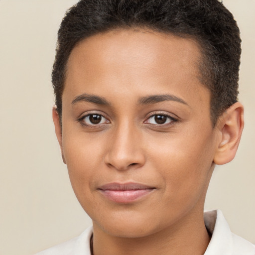 Joyful latino young-adult female with short  brown hair and brown eyes