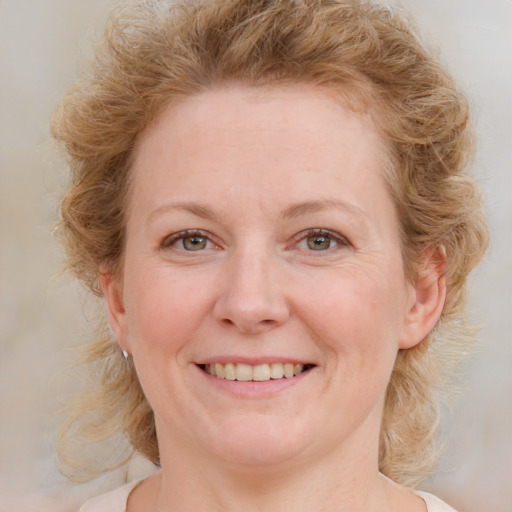 Joyful white young-adult female with medium  brown hair and blue eyes