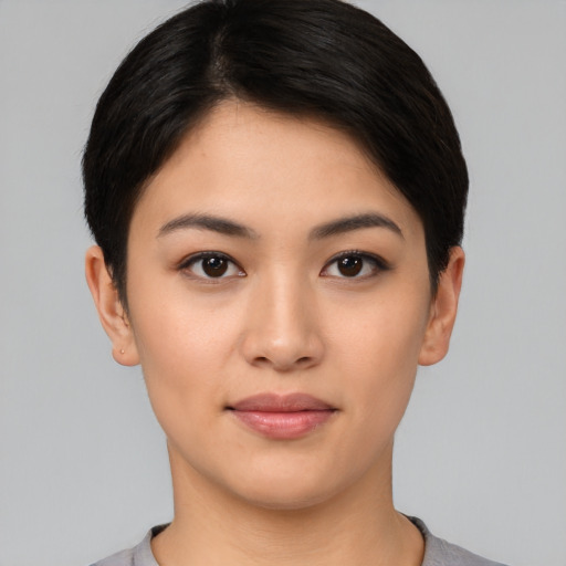 Joyful asian young-adult female with short  black hair and brown eyes