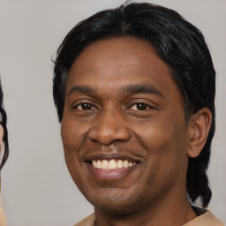 Joyful black young-adult male with short  black hair and brown eyes