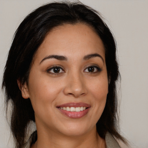 Joyful white young-adult female with long  brown hair and brown eyes