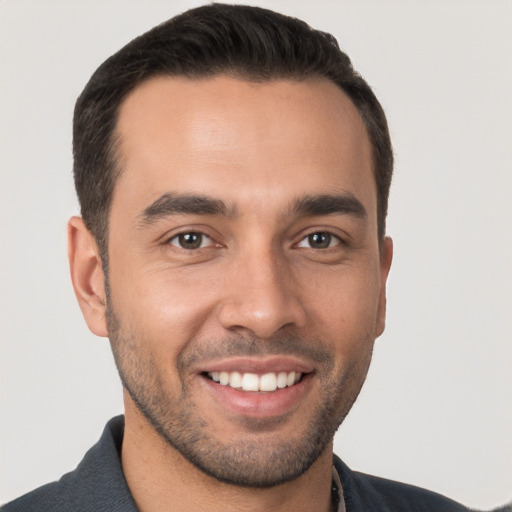 Joyful white young-adult male with short  brown hair and brown eyes