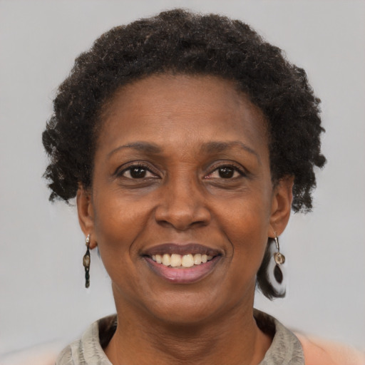 Joyful black adult female with short  brown hair and brown eyes