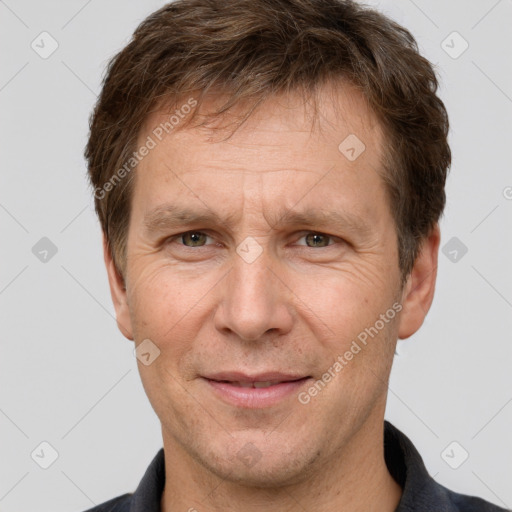 Joyful white adult male with short  brown hair and grey eyes