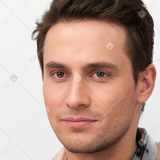 Joyful white young-adult male with short  brown hair and brown eyes