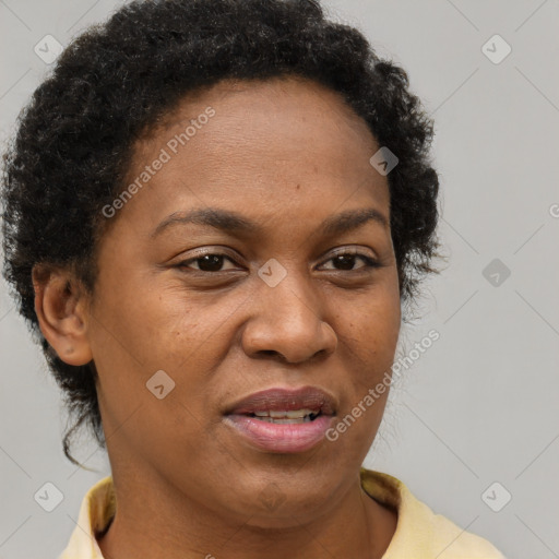 Joyful black adult female with short  brown hair and brown eyes