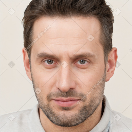 Joyful white adult male with short  brown hair and brown eyes