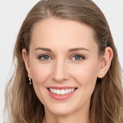 Joyful white young-adult female with long  brown hair and grey eyes