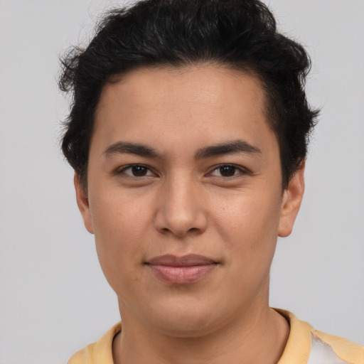 Joyful latino young-adult male with short  brown hair and brown eyes