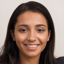 Joyful latino young-adult female with long  brown hair and brown eyes