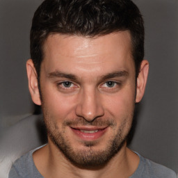 Joyful white young-adult male with short  brown hair and brown eyes