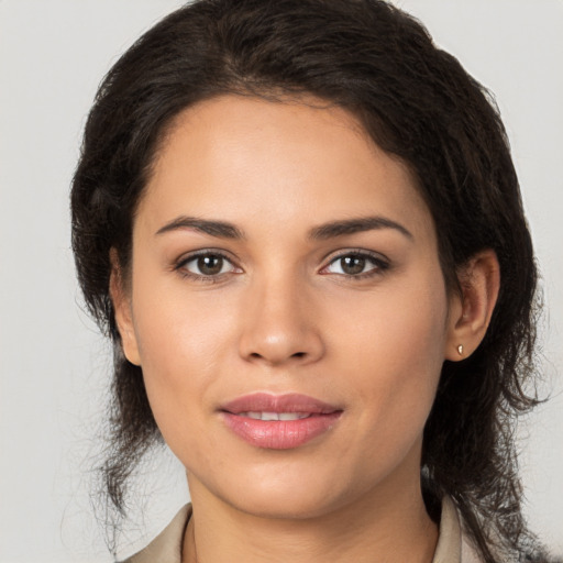 Joyful latino young-adult female with medium  brown hair and brown eyes