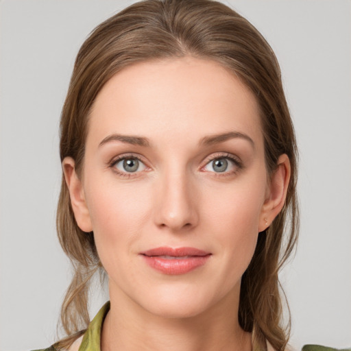 Joyful white young-adult female with medium  brown hair and green eyes