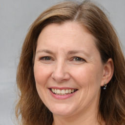 Joyful white adult female with long  brown hair and brown eyes