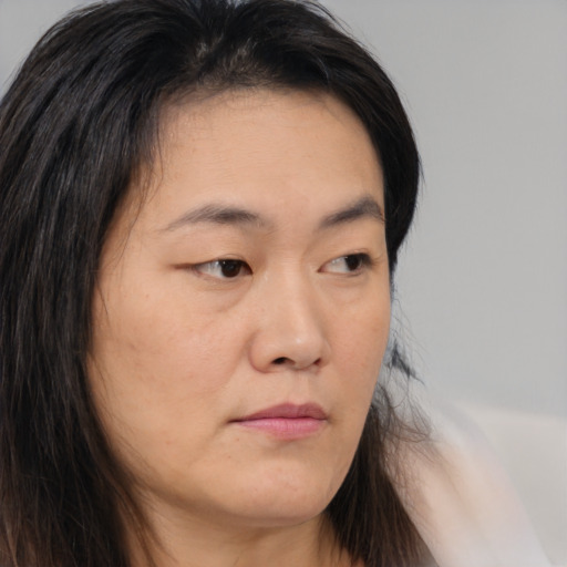 Neutral asian young-adult female with medium  brown hair and brown eyes