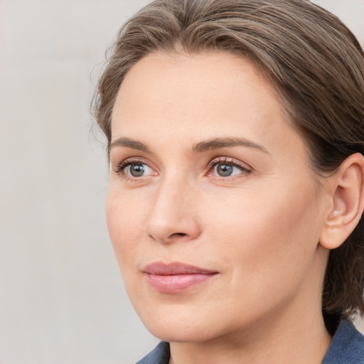 Joyful white young-adult female with medium  brown hair and blue eyes