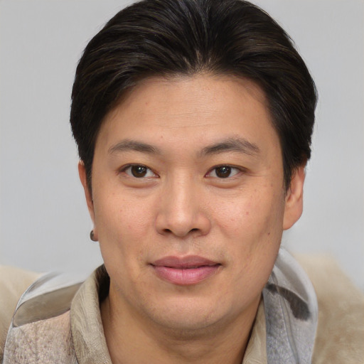 Joyful white adult male with short  brown hair and brown eyes
