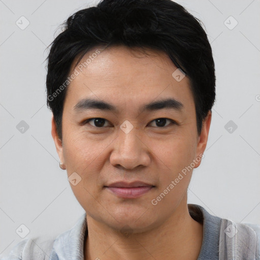 Joyful asian young-adult male with short  black hair and brown eyes